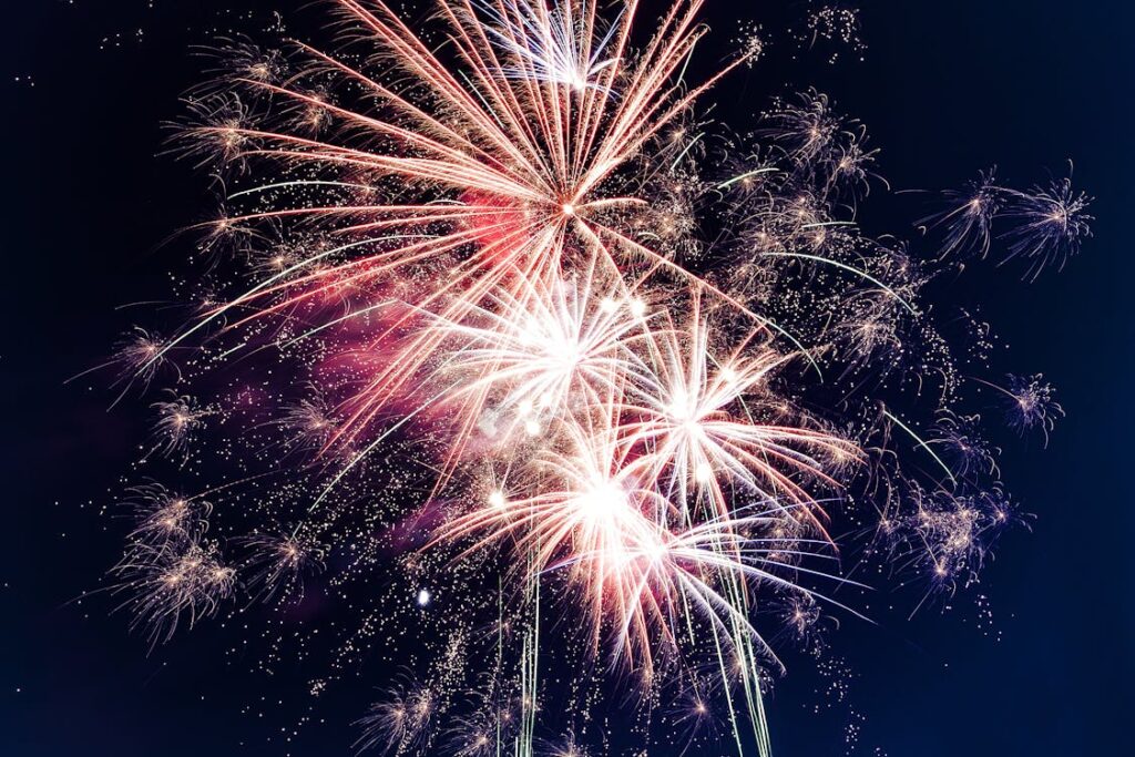 Free Colorful fireworks exploding in the night sky creating a festive atmosphere. Stock Photo